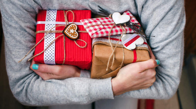 A lot of gifts on Valentine's Day in the hands of a girl | Best Valentines Gifts For Women Who Love Makeup | valentines gift ideas | Featured