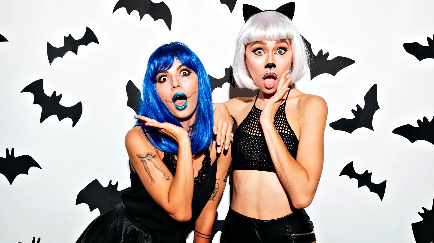 Picture of two emotional young women in halloween costumes on party over white background | Easy & Cheap Adult Halloween Costume Ideas | Featured