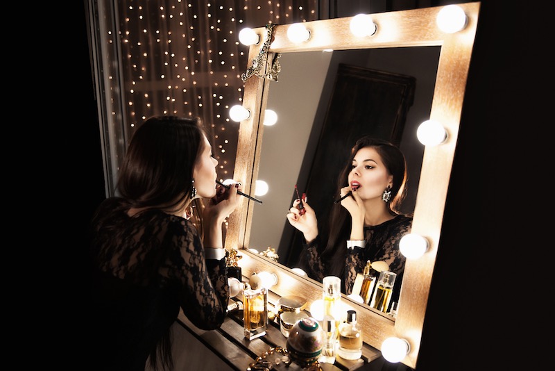 beautiful-brunette-girl-looks-makeup-mirror- | makeup looks