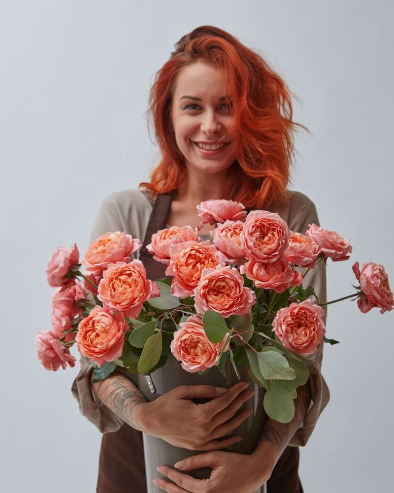 young-woman-with-a-big-vase-of-roses | long hairstyles