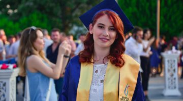 Smiling Woman Wearing Graduation Dress-graduation makeup tutorials-px-feature