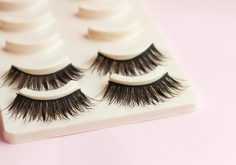 false eyelashes on pink background artificial | spring cleaning checklist