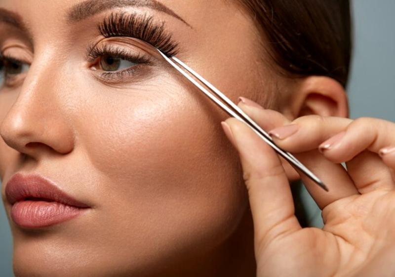 eyelashes beautiful woman applying false tweezers | easiest way to put on fake eyelashes