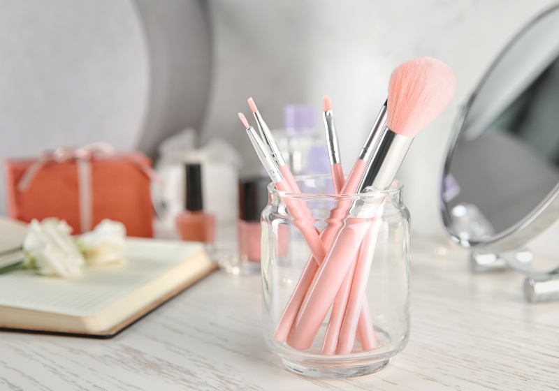 glass jar cosmetic brushes on table | walmart makeup organizers