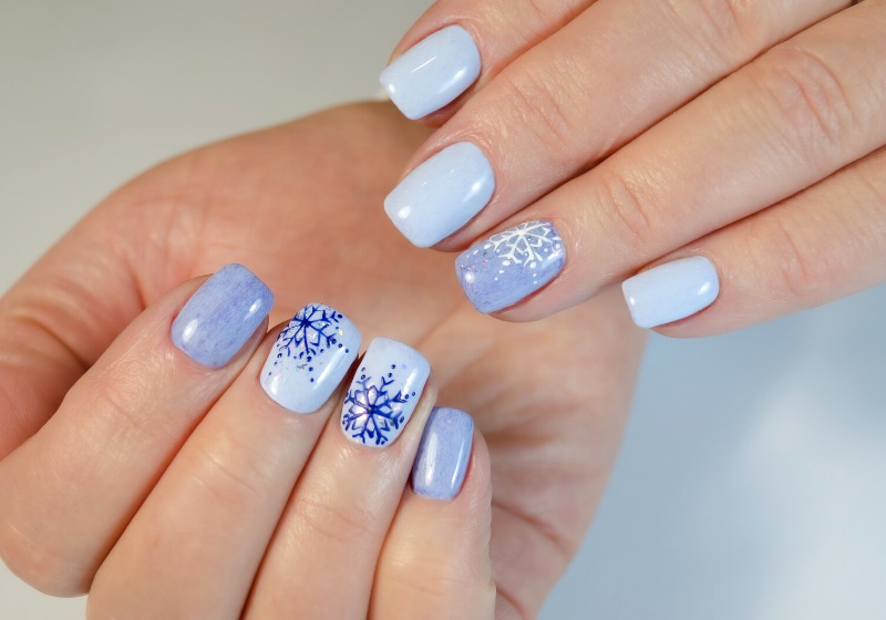 hand young woman blue manicure design | snowflake nails blue