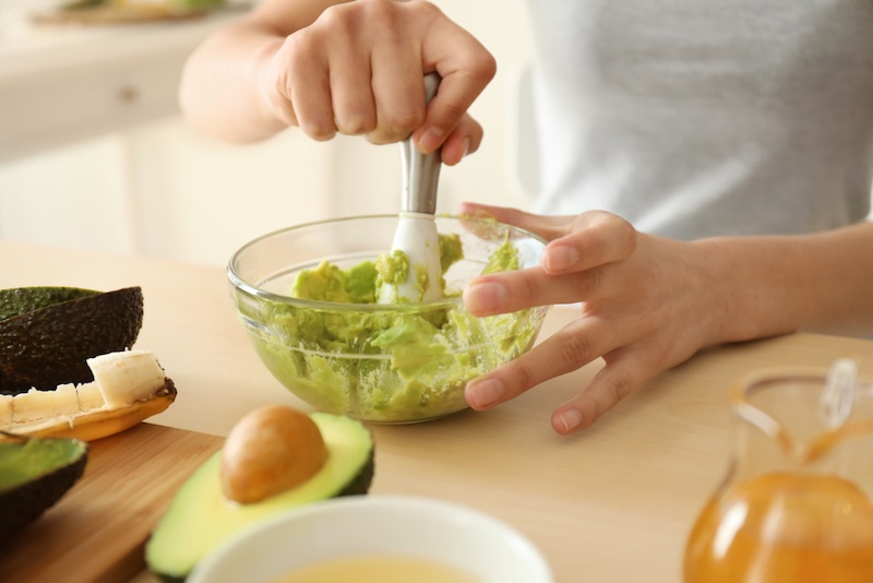 woman-making-nourishing-mask-avocado-kitchen | homemade tips for clear skin