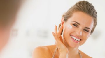 Happy young woman applying cream in bathroom | The Best BB Cream Worth Ditching Your Foundation For | best bb cream | Featured