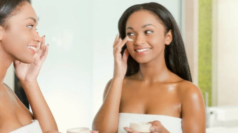 Beautiful young African woman spreading cream on her face | 2020 Skincare Trends: Biggest Beauty Innovations To Watch Out For | skin care trend | Featured