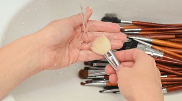 Person Washing Brushes | Effective DIY Makeup Brush Cleaner Using Available Household Products | how to clean makeup brushes | Featured