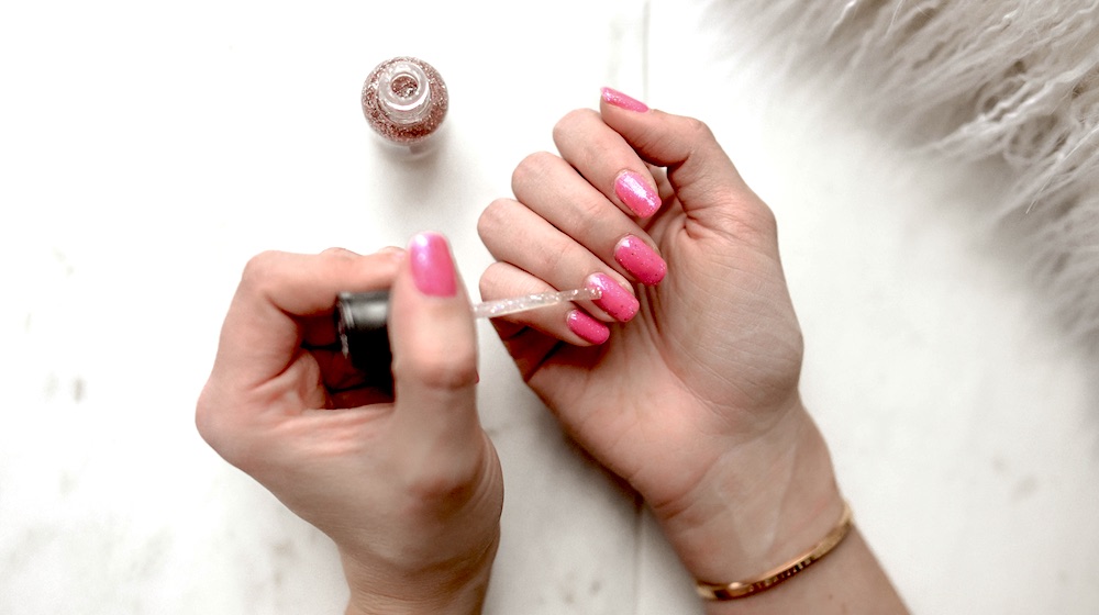 Woman with pink manicure | How To Fix A Broken Nail At Home Using Household Items | how to fix a broken nail with gel polish on | Featured