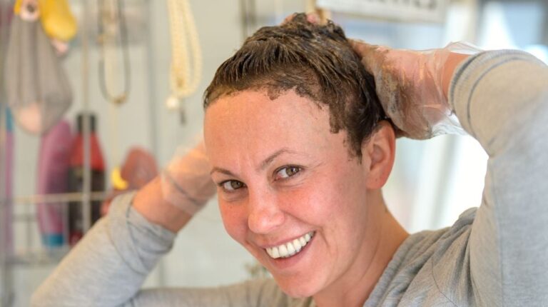 woman applying dye | How To Dye Roots Darker Than The Rest Of Your Hair At Home | Featured