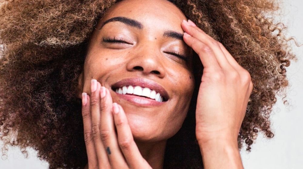 beautiful black woman smiling | Best Clean And Vegan Skincare Brands You Didn't Know About | Featured
