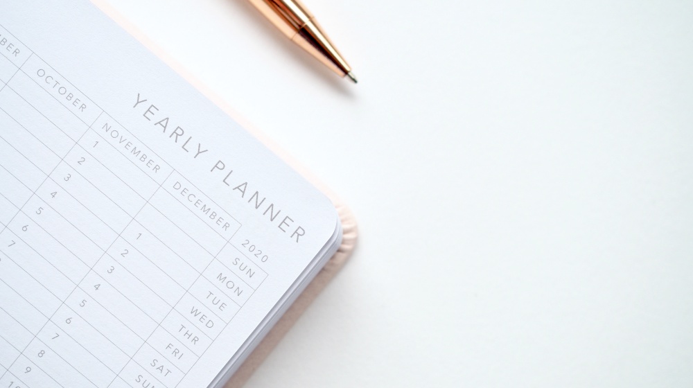 close up photo of yearly planner beside a pen | How To Safely and Properly Bleach Hair At Home | px