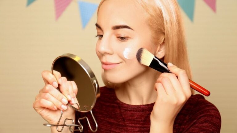 beautiful young woman applying moisturizing cream | Best Makeup Primer For Dry Skin According To Pros | Featured