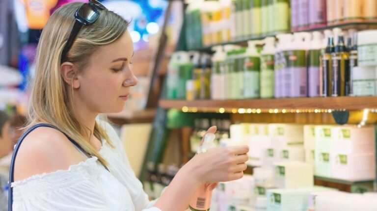 young woman choosing cosmetic cream | Cult Favorite Beauty Brands You Need To Try (If You Haven't Yet) | Featured
