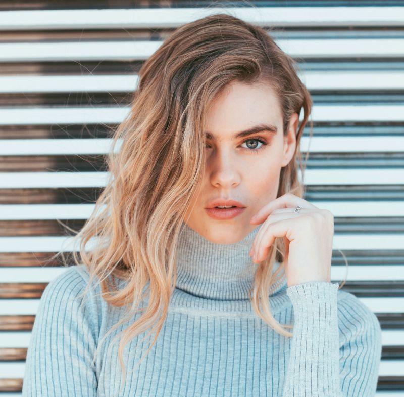 woman wearing a grey turtleneck sweater | Trendy Fall Hair Colors To Update Your Look For The Season