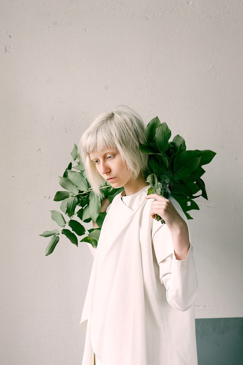 photography-of-a-woman-holding-green-leaves | How To Grow Out Natural Hair Color Seamlessly