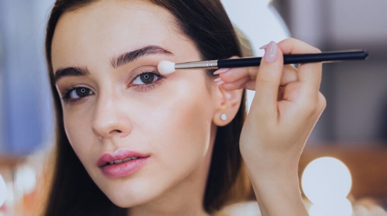 pink-lips-greeneyed-goodlooking-woman-using | 14 Best Eye Makeup Looks For Every Eye Color | featured