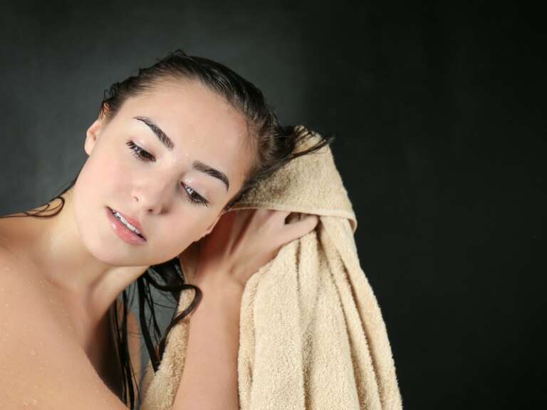 women dry her hair with microfiber towel