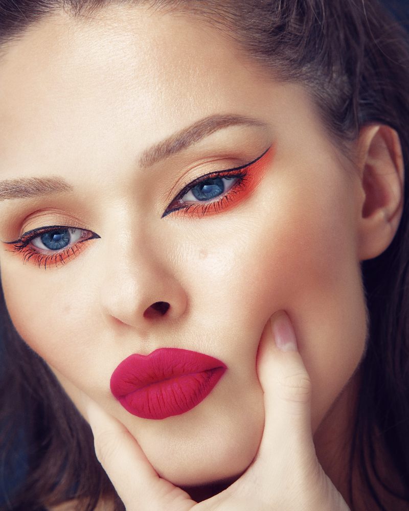 beautiful brunette girl neon graphic eyeliner makeup and hot red pink lips pouting | graphic liner set