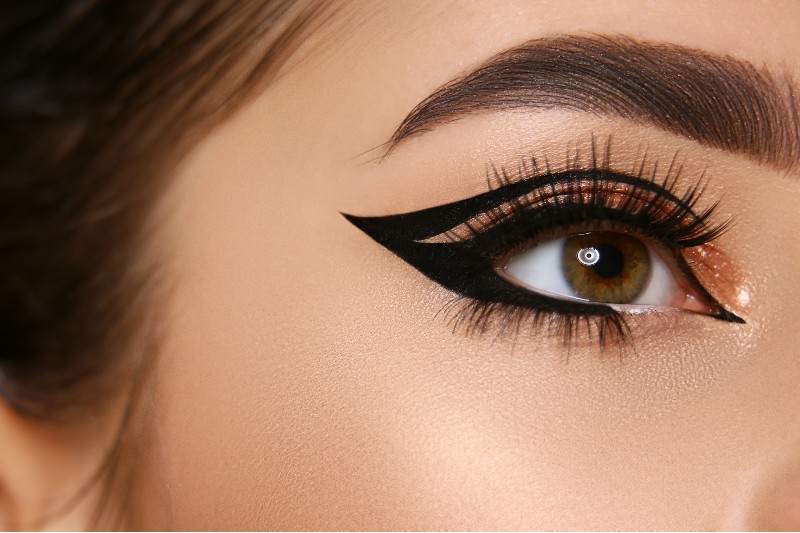 close woman eye sexy eyeliner golden shadow | graphic liner look