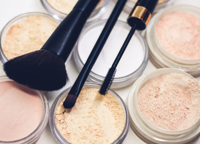 three makeup brushes on top of compact powders photo | top cosmetic brands in the world