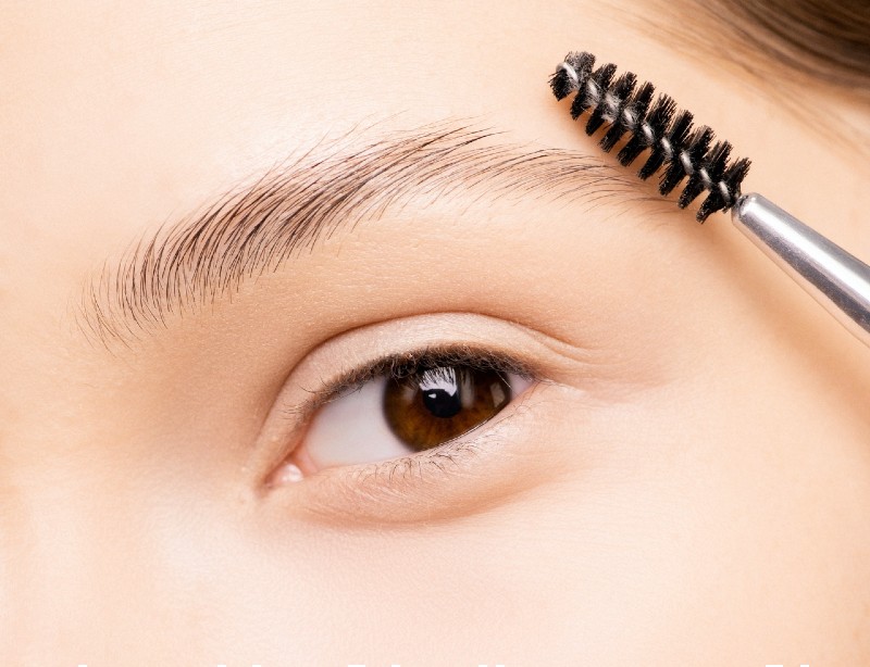 woman applying mascara | eyebrow meaning