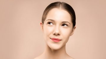 woman with red lipstick looking up | collagen serum firming