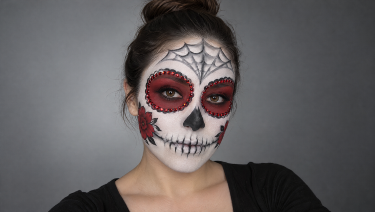 Day of the Dead makeup tutorial step 12: finished white, red and black skull makeup with crystals and cheek flowers