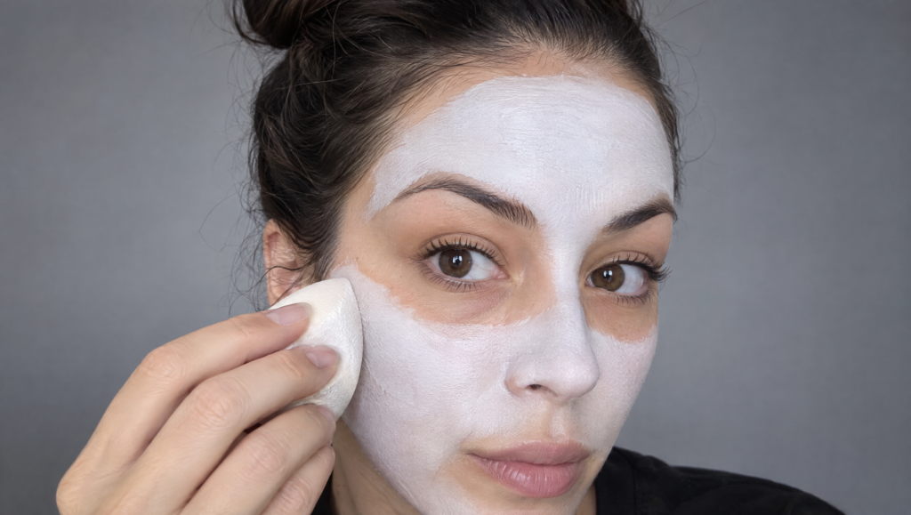 Day of the Dead makeup tutorial step 2: white cream base being dabbed onto the forehead and cheeks